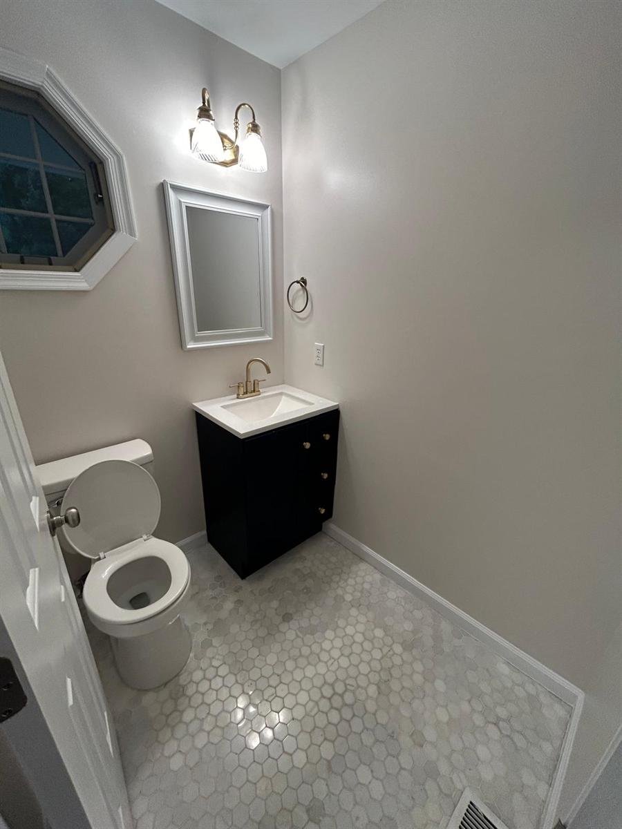Half bathroom cleaned top to bottom, with polished floor tile